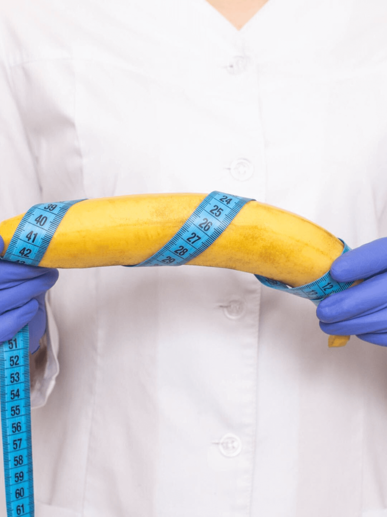 An image of a doctor holding a banana with measuring tape wrapped around it